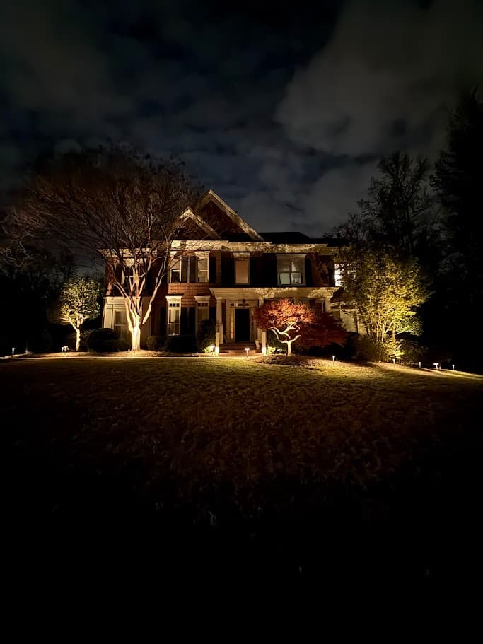 The Whitney Sanctuary full-brick facade illuminated at night, 7810 Stonehaven Drive Waxhaw NC